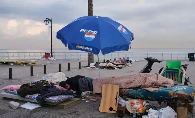 Displaced people fleeing Israeli airstrikes in Dahiyeh, Beirut's southern suburbs, sleep along the Mediterranean Sea in Beirut, Lebanon, Saturday, March 7, 2026. (AP Photo/Bilal Hussein)