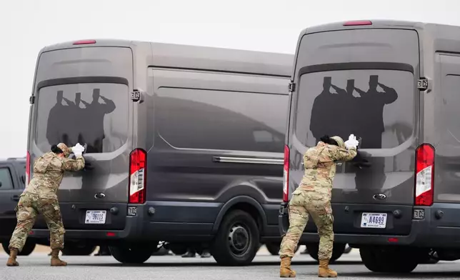 Door attendants U.S. Air Force Master Sgt. Christina Jiminez and Senior Airman Awng Dingrin secure the doors of the transfer vans containing the remains of U.S. Army Reserve soldiers Maj. Jeffrey O'Brien, 45, of Indianola, Iowa, Capt. Cody Khork, 35, of Winter Haven, Florida, Chief Warrant Officer 3 Robert Marzan, 54, of Sacramento, Sgt. 1st Class Nicole Amor, 39, of White Bear Lake, Minnesot, Sgt. 1st Class Noah Tietjens, 42, of Bellevue, Nebraska and Sgt. Declan Coady, 20, of West Des Moines, Iowa, who were killed in a drone strike at a command center in Kuwait after the U.S. and Israel launched its military campaign against Iran, during a casualty return, Saturday, March 7, 2026, at Dover Air Force Base, Del. (AP Photo/Mark Schiefelbein)