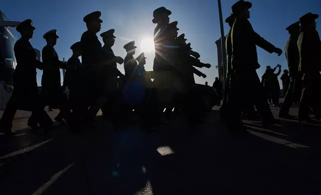 Military delegates arrive for a plenary session of the National People's Congress (NPC) held at the Great Hall of the People in Beijing, Monday, March 9, 2026. (AP Photo/Ng Han Guan)