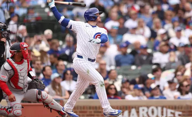 Chicago Cubs Ian Happ (8) hits a solo home run during the fourth inning of a baseball game against the Washington Nationals at Wrigley Field on Sunday, March 29, 2026, in Chicago. (AP Photo/Geoff Stellfox)
