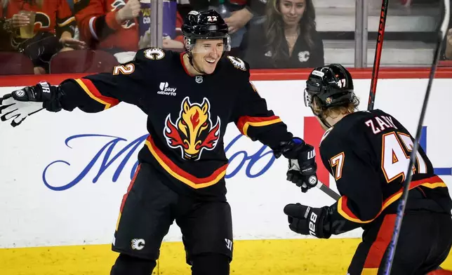Calgary Flames' Ryan Strome, left, celebrates his goal with teammate Connor Zary during second period NHL hockey action against the Carolina Hurricanes in Calgary on Saturday, March 7, 2026. (Jeff McIntosh/The Canadian Press via AP)