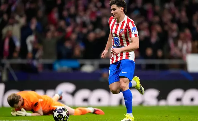 Atletico Madrid's Julian Alvarez goes round Tottenham's goalkeeper Antonin Kinsky to score his side's third goal during the first leg of the Champions League round of 16 soccer match between Atletico Madrid and Tottenham in Madrid, Spain, Tuesday, March 10, 2026. (AP Photo/Jose Breton)