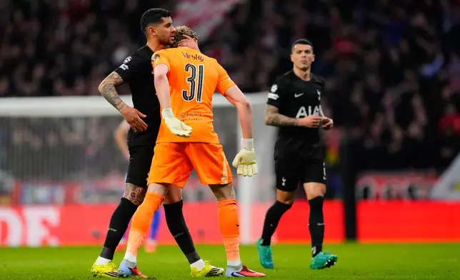 Tottenham's goalkeeper Antonin Kinsky, center, is greeted by teammates after being substituted during the first leg of the Champions League round of 16 soccer match between Atletico Madrid and Tottenham in Madrid, Spain, Tuesday, March 10, 2026. (AP Photo/Jose Breton)