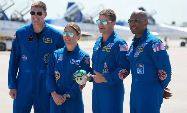 Artemis 2 crew members, from left, Mission Spc. Jeremy Hansen, of Canada, Mission Spc. Christina Koch, Commander Reid Wiseman, and Pilot Victor Glover pose for a photo after the crew's arrival at the Kennedy Space Center Friday, March 27, 2026, in Cape Canaveral, Fla. (AP Photo/Chris O'Meara)
