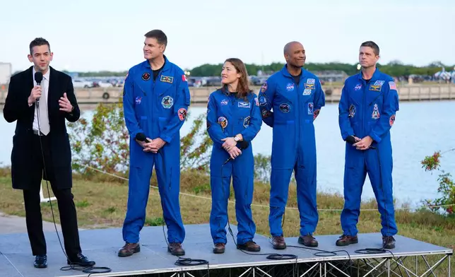 FILE - NASA administrator Jared Isaacman, left, answers questions during a news conference, next to the crew of the new moon rocket, Artemis II, from left, Canadian Space Agency astronaut Jeremy Hansen, mission specialist Christina Koch, pilot Victor Glover and commander Reid Wiseman at the Kennedy Space Center, Jan. 17, 2026, in Cape Canaveral, Fla. (AP Photo/John Raoux, FIle)