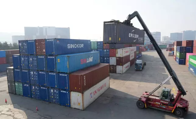 A crane unloads a container at the Uiwang ICD Terminal in Uiwang, South Korea, Thursday, March 12, 2026. (AP Photo/Ahn Young-joon)