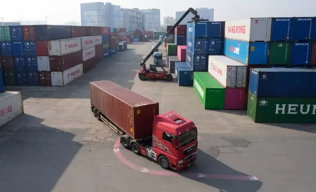 A truck runs by containers at the Uiwang ICD Terminal in Uiwang, South Korea, Thursday, March 12, 2026. (AP Photo/Ahn Young-joon)