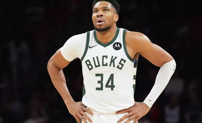 Milwaukee Bucks forward Giannis Antetokounmpo (34) looks up at the score board during the first half of an NBA basketball game against the Miami Heat Thursday, March 12, 2026, in Miami. (AP Photo/Marta Lavandier)