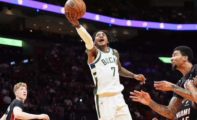 Milwaukee Bucks guard Kevin Porter Jr. (7) drives to the basket during the first half of an NBA basketball game against the Miami Heat Thursday, March 12, 2026, in Miami. (AP Photo/Marta Lavandier)