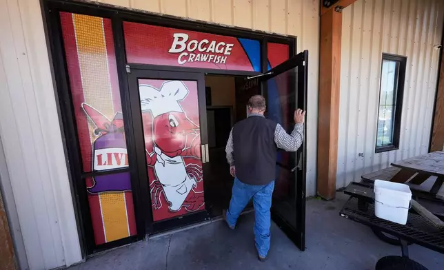 Alan Lawson enters the Bocage Crawfish processing facility in Crowley, La., Thursday, March 19, 2026. (AP Photo/Gerald Herbert)