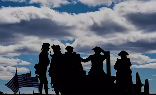 Reenactors stand atop Dorchester Heights in an Evacuation Day ceremony marking the 1776 departure of British troops from the city during the American Revolutionary War, Tuesday, March 17, 2026, in Boston. (AP Photo/Robert F. Bukaty)