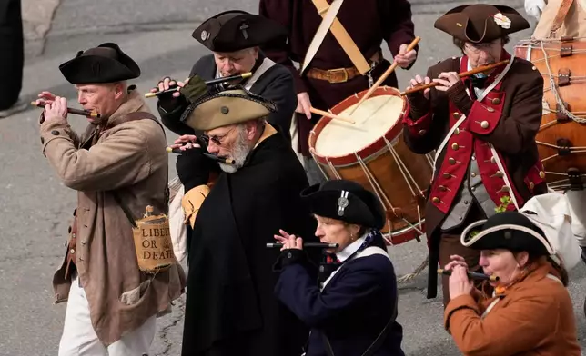 Members of a fife and drum band march in a procession during an Evacuation Day ceremony marking the 1776 departure of British troops from the city during the American Revolutionary War, Tuesday, March 17, 2026, in Boston. (AP Photo/Robert F. Bukaty)