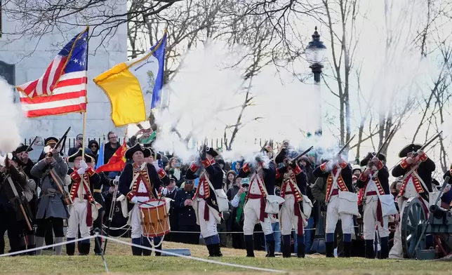 Reenactors fire muskets during an Evacuation Day ceremony marking the 1776 departure of British troops from the city during the American Revolutionary War, Tuesday, March 17, 2026, in Boston. (AP Photo/Robert F. Bukaty)