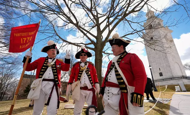 Pawtucket Rangers Militia reenactors assemble in an Evacuation Day ceremony marking the 1776 departure of British troops from the city during the American Revolutionary War, Tuesday, March 17, 2026, in Boston. (AP Photo/Robert F. Bukaty)