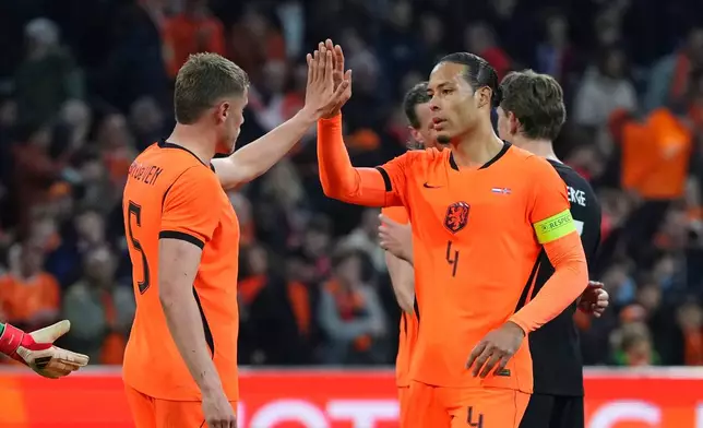 Netherlands' Virgil van Dijk, right, and Natan Ake celebrate after the international friendly soccer match between the Netherlands and Norway in Amsterdam, Netherlands, Friday, March 27, 2026. (AP Photo/Peter Dejong)