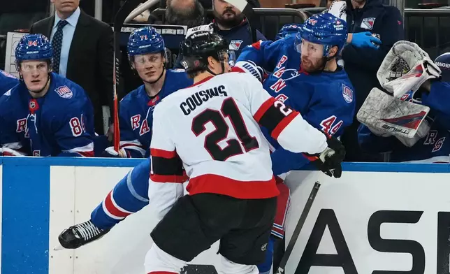 Ottawa Senators' Nick Cousins (21) checks New York Rangers' Vladislav Gavrikov (44) during the second period of an NHL hockey game Monday, March 23, 2026, in New York. (AP Photo/Frank Franklin II)