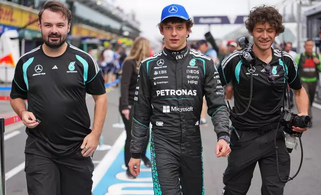 Mercedes driver Andrea Kimi Antonelli of Italy walks down pit lane with teammates following the qualifying session for the Australian Formula One Grand Prix at Albert Park, in Melbourne, Australia, Saturday, March 7, 2026. (AP Photo/Asanka Brendon Ratnayake)