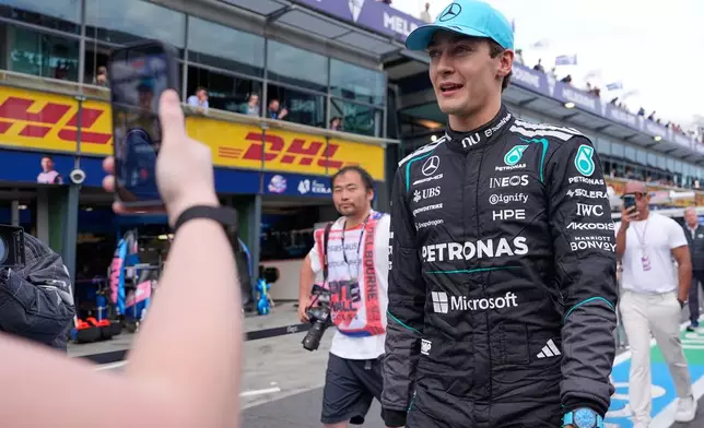 Mercedes driver George Russell of Britain walks down pit lane after winning the qualifying session for the Australian Formula One Grand Prix at Albert Park, in Melbourne, Australia, Saturday, March 7, 2026. (AP Photo/Asanka Brendon Ratnayake)