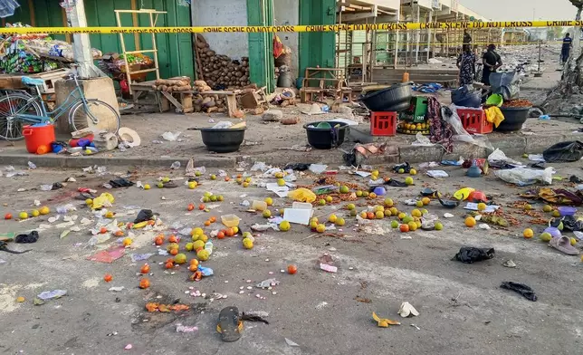 Police officers are seen at the scene of a bomb blast at a market in Maiduguri, Nigeria, Tuesday, March 17, 2026. (AP Photo/Jossy Ola )