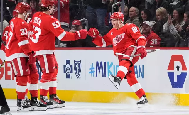 Detroit Red Wings right wing Patrick Kane (88) celebrates his goal with Patrick Kane (88) against the Calgary Flames in the second period of an NHL hockey game Monday, March 16, 2026, in Detroit. (AP Photo/Paul Sancya)