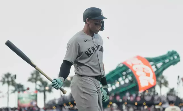 New York Yankees' Aaron Judge walks to the dugout after striking out during the sixth inning of a baseball game against the San Francisco Giants in San Francisco, Wednesday, March 25, 2026. (AP Photo/Jeff Chiu)