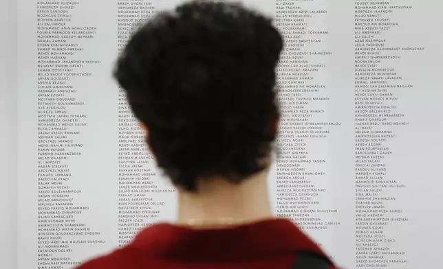 People read the names of Iranian lives that were lost during a gathering in New York, on Saturday, March 14, 2026, for the upcoming Nowruz, Iranian/Persian New Year's day. (AP Photo/Heather Khalifa)