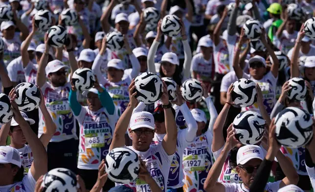 People practice soccer skills in an attempt to set a Guinness World Record for the "largest soccer class" at the Zocalo in Mexico City, Sunday, March 15, 2026. (AP Photo/Marco Ugarte)