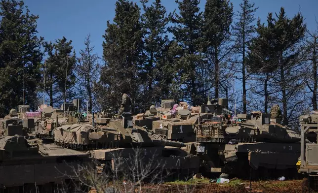 Israeli soldiers are seen along the border with Lebanon in northern Israel, Tuesday, March 17, 2026. (AP Photo/Ariel Schalit)