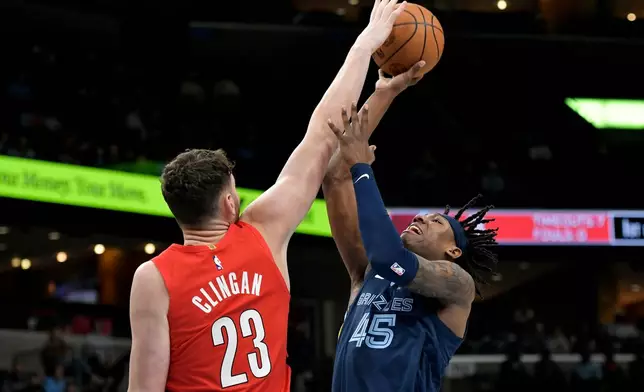 Portland Trail Blazers center Donovan Clingan (23) blocks a shot by Memphis Grizzlies forward GG Jackson II (45) in the first half of an NBA basketball game, Wednesday, March 4, 2026, in Memphis, Tenn. (AP Photo/Brandon Dill)