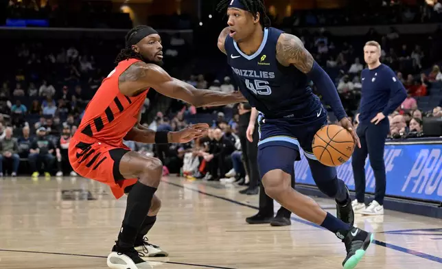 Memphis Grizzlies forward GG Jackson II (45) drives against Portland Trail Blazers forward Jerami Grant in the first half of an NBA basketball game, Wednesday, March 4, 2026, in Memphis, Tenn. (AP Photo/Brandon Dill)