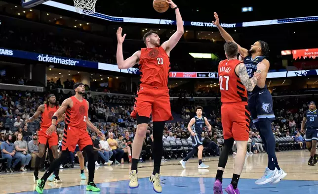 Portland Trail Blazers center Donovan Clingan (23) grabs a rebound in the first half of an NBA basketball game against the Memphis Grizzlies Wednesday, March 4, 2026, in Memphis, Tenn. (AP Photo/Brandon Dill)