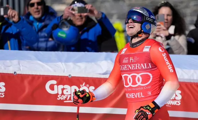 Switzerland's Marco Odermatt reacts at the finish area of an alpine ski, men's World Cup downhill race, in Courchevel, France, Friday, March 13, 2026. (AP Photo/Giovanni Auletta)