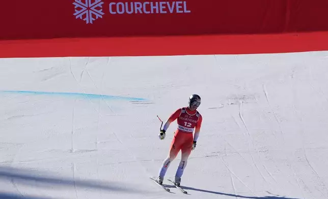 Switzerland's Franjo von Allmen arrives at the finish area after failing to complete an alpine ski, men's World Cup downhill race, in Courchevel, France, Friday, March 13, 2026. (AP Photo/Giovanni Auletta)