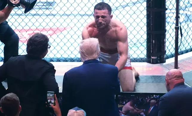 FILE - President Donald Trump congratulates Georgia's Merab Dvalishvili, after he won his bantamweight title bout against Sean O'Malley, during the UFC-316 mixed martial arts event, at the Prudential Center, June 7, 2025, in Newark, N.J. (AP Photo/Manuel Ceneta, File)