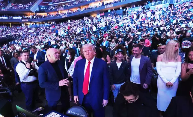 FILE - President Donald Trump attends the UFC-316 mixed martial arts event, at the Prudential Center, June 7, 2025, in Newark, N.J., as UFC's Dana White, left, looks on. (AP Photo/Frank Franklin II, File)