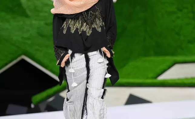 A model wears a creation from the Louis Vuitton Fall/Winter 2026-2027 Women's collection presented in Paris, Tuesday, March 10, 2026. (AP Photo/Aurelien Morissard)