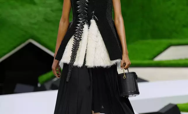 A model wears a creation from the Louis Vuitton Fall/Winter 2026-2027 Women's collection presented in Paris, Tuesday, March 10, 2026. (AP Photo/Aurelien Morissard)