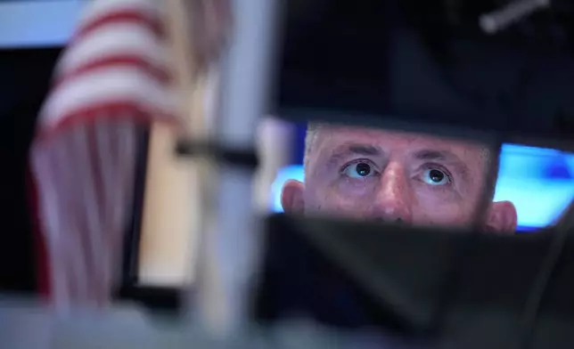 Traders work on the floor at the New York Stock Exchange in New York, Tuesday, March 10, 2026. (AP Photo/Seth Wenig)