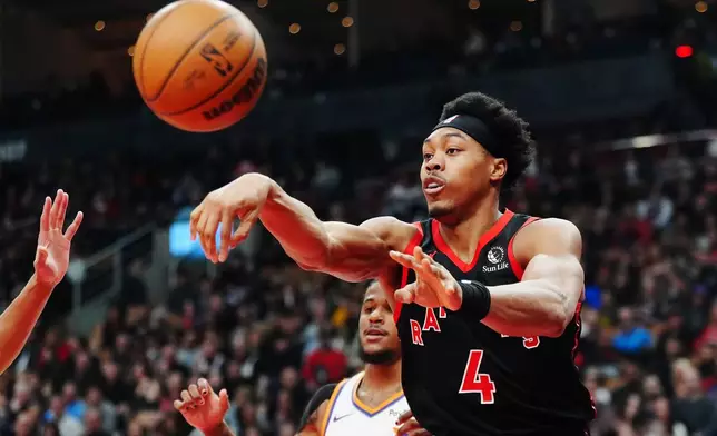Toronto Raptors' Scottie Barnes (4) passes the ball against the Phoenix Suns during first-half NBA basketball game action in Toronto, Friday, March 13, 2026. (Frank Gunn/The Canadian Press via AP)
