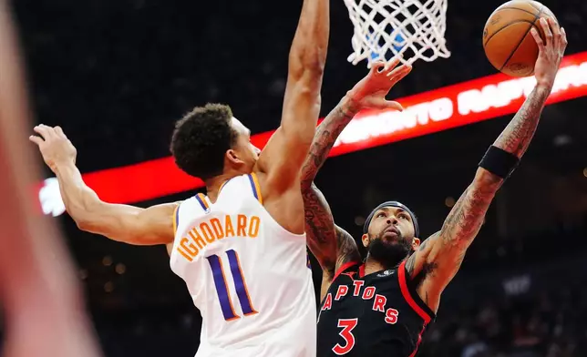 Toronto Raptors' Brandon Ingram (3) shoots past Phoenix Suns' Oso Ighodaro (11) during the first half of an NBA basketball game in Toronto, Friday, March 13, 2026. (Frank Gunn/The Canadian Press via AP)