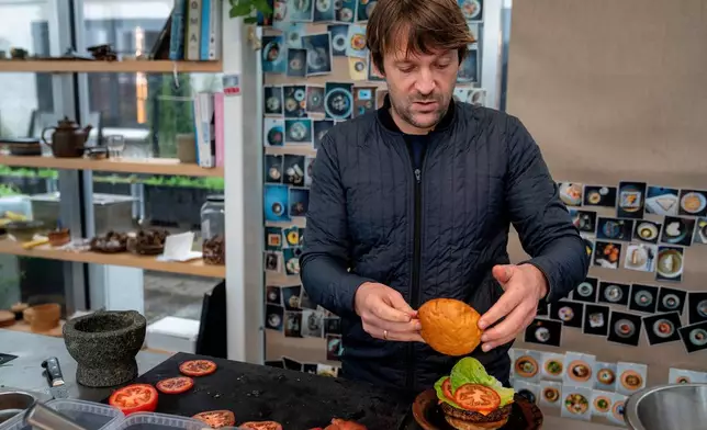 Noma's chef René Redzepi prepares a vegetarian burger in a restaurant, in Copenhagen, Nov. 24, 2024. (Soeren Bidstrup/Ritzau Scanpix via AP)