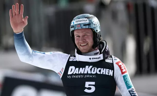 Norway's Timon Haugan celebrates winning an alpine ski, men's slalom race, at the Lillehammer World Cup Finals, in Hafjell, Norway, Wednesday, March 25, 2026. (AP Photo/Gabriele Facciotti)