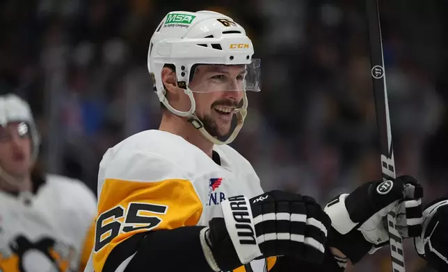 Pittsburgh Penguins defenseman Erik Karlsson reacts after scoring against the Colorado Avalanche in the second period of an NHL hockey game Monday, March 16, 2026, in Denver. (AP Photo/David Zalubowski)