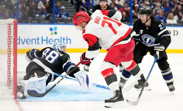 Tampa Bay Lightning goaltender Andrei Vasilevskiy (88) makes a save on a shot by Carolina Hurricanes left wing Taylor Hall (71) during the third period of an NHL hockey game Saturday, March 14, 2026, in Tampa, Fla. (AP Photo/Chris O'Meara)