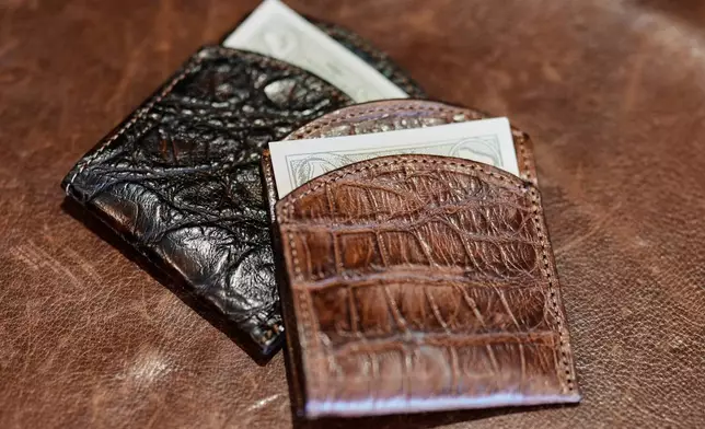 Front pocket wallets made from American alligator are displayed at the Col. Littleton leather goods store Friday, March 6, 2026, in Lynnville, Tenn. (AP Photo/George Walker IV)