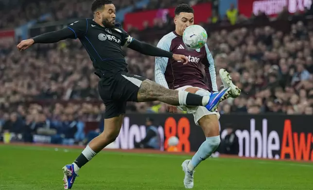Chelsea's Reece James, left, tackles Aston Villa's Morgan Rogers during their English Premier League soccer match between Aston Villa and Chelsea in Birmingham, England, Wednesday, March 4, 2026. (AP Photo/Dave Shopland)