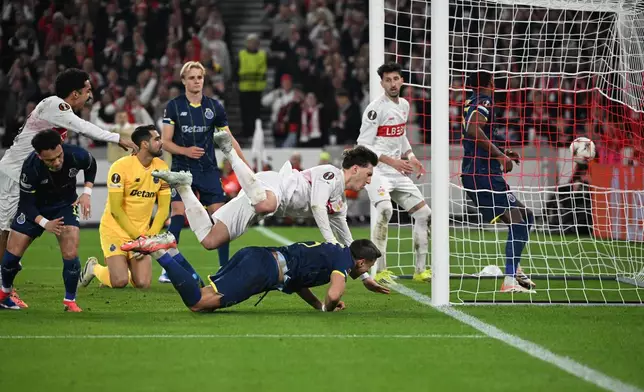 Stuttgart's Angelo Stiller, top centre, scores a goal that was disallowed after a VAR review, during the round of 16, first leg soccer match of the Europa League between VfB Stuttgart and FC Porto, in Stuttgart, Germany, Thursday March 12, 2026. (Marijan Murat/dpa via AP)