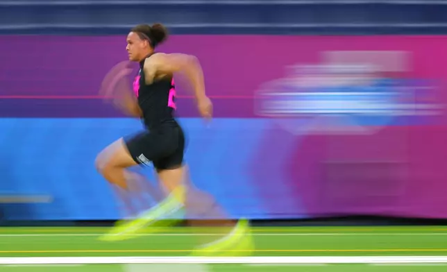 In this photograph taken with a slow shutter speed, Vanderbilt tight end Eli Stowers (25) runs the 40-yard dash at the NFL football scouting combine in Indianapolis, Friday, Feb. 27, 2026. (AP Photo/Julio Cortez)