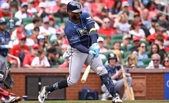 Tampa Bay Rays' Yandy Díaz hits an RBI single in the second inning of a baseball game against the St. Louis Cardinals, Sunday, March 29, 2026, in St. Louis. (AP Photo/Joe Puetz)