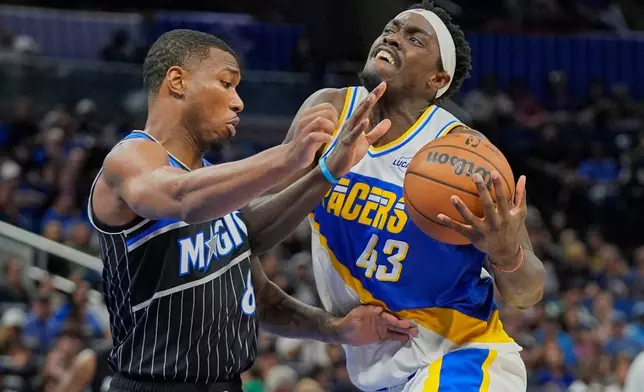 Indiana Pacers forward Pascal Siakam (43) drives against Orlando Magic forward Jamal Cain, left, during the second half of an NBA basketball game, Monday, March 23, 2026, in Orlando, Fla. (AP Photo/John Raoux)